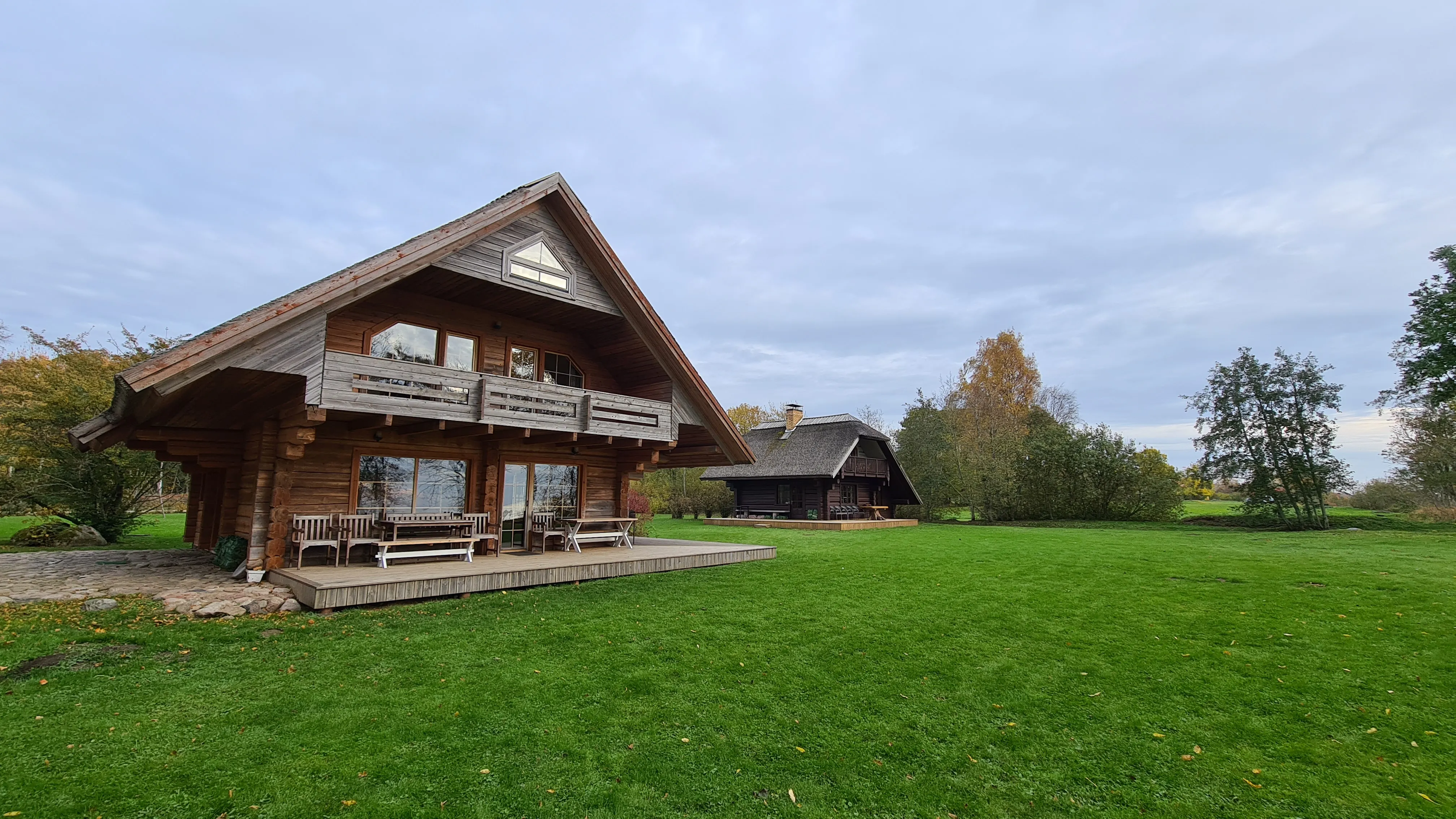 The Klintskalni property with the large log house and a second house behind, seen from the garden